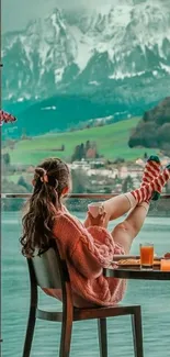 Woman relaxing by window with mountain view.