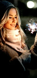 Smiling woman holding a sparkler at night.