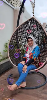 Woman relaxing on outdoor swing with heart patterns.