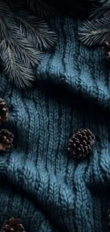 Pinecones on a blue knit fabric background wallpaper.