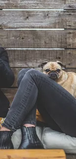 Cozy pug snuggling indoors with friends, rustic setting.