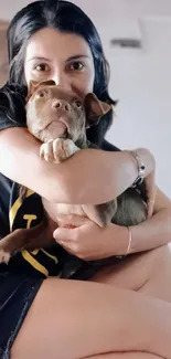 Woman lovingly hugging a puppy, expressing warmth and affection.