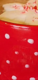 Close-up of a red polka dot mug with hot chocolate.