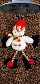 Festive snowman laying on coffee beans, adorned in red and green.