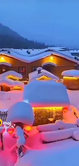 Snowy cabins at dusk with warm lights glowing against a blue sky.