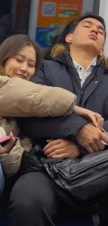 Two people resting on a subway wearing winter coats.