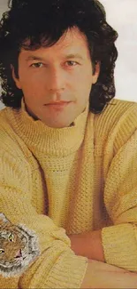 Portrait of a man in a knitted light gold sweater for wallpaper.