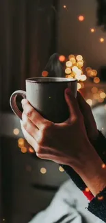 Hands holding a warm mug with glowing bokeh lights in the background.