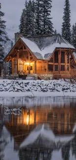 Cozy cabin by a snowy lake reflecting warm light.