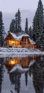 Wooden cabin by snowy lake with pine trees and reflection.