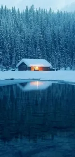 Cozy winter cabin with lights by a reflective snowy lake.