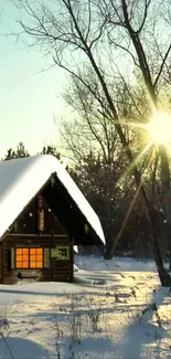 Snowy cabin with sunrise and trees in tranquil winter scene.