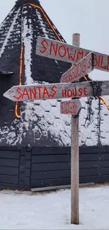 Snow-covered cabin with a festive signpost in a winter setting.