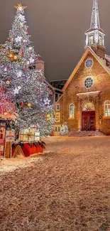 Snowy scene with Christmas tree and illuminated church at night.