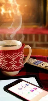 Cozy winter setting with fireplace, knit mug, and plaid red blanket.