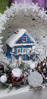 A snowy winter scene with a cozy blue house and festive decorations.