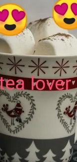 Cozy winter cup with marshmallows and emojis for tea lovers.