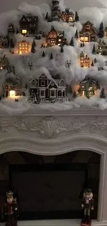 Cozy winter village display on a white fireplace mantle.