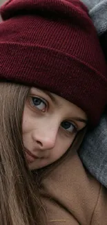 Girl wearing a burgundy beanie for a cozy winter wallpaper.