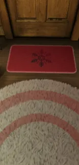 Warm wooden floor with a red snowflake mat.