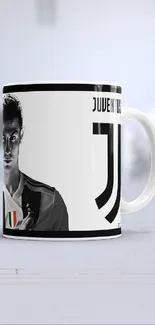 White and black CR7 Juventus mugs on display.