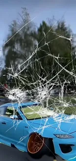 Blue car with cracked glass effect in scenic street.