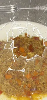 Cracked glass over noodles on a plate.