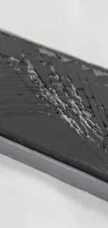 Cracked screen mobile phone wallpaper with intricate glass pattern.