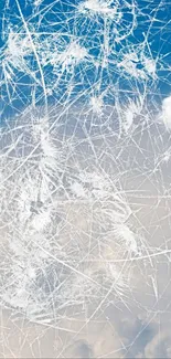 Abstract cracked ice design with sky and clouds.