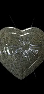 Cracked stone heart on a black background mobile wallpaper.