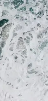 Aerial view of crashing ocean waves creating white foam.