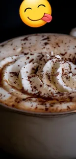 Creamy coffee with whipped topping and playful emoji.