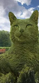 Giant cat-shaped topiary art in a lush garden setting with a vibrant sky.