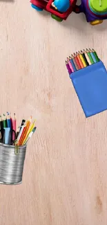 Colorful art supplies on a wooden desk.