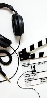 Film production wallpaper with headphones and clapperboard on white background.