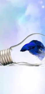 Blue fish in a lightbulb with pastel background.