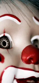 Close-up of a creepy clown doll face with vivid red and white paint.