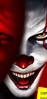 Creepy clown with red tones, scary face in dark background.
