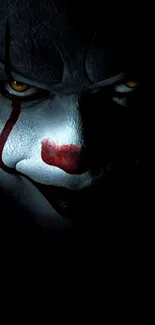 Creepy clown face with dark shadows, eerie wallpaper.