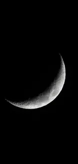 Crescent moon against a black night sky.