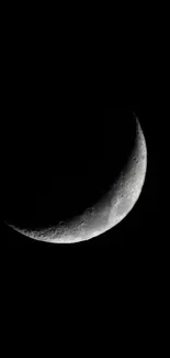 Crescent moon against a black sky, creating a minimalist night scene.