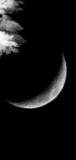 Serene crescent moon with clouds in night sky, black and white.