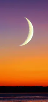 Crescent moon over vibrant orange and purple sunset.