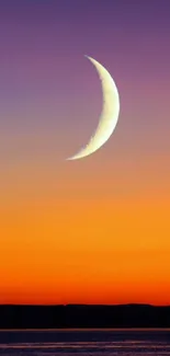 Crescent moon against a vibrant sunset gradient sky.