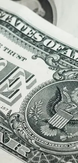 Close-up of a one dollar bill, showcasing currency details.