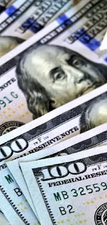 Stacked US hundred dollar bills wallpaper showcasing wealth.