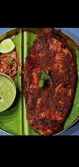 Crispy fish and mint chutney on banana leaf plate.