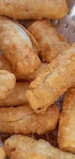 Golden brown crispy fried bananas in a colander.