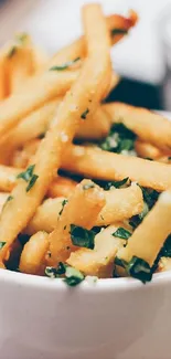 Crispy herb-seasoned French fries in bowl.