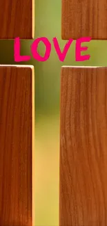 Wooden cross with 'LOVE' in pink text on mobile wallpaper.